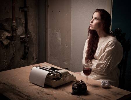 10342679-a-mad-girl-wearing-a-straight-jacket-in-front-of-a-typewriter.jpg