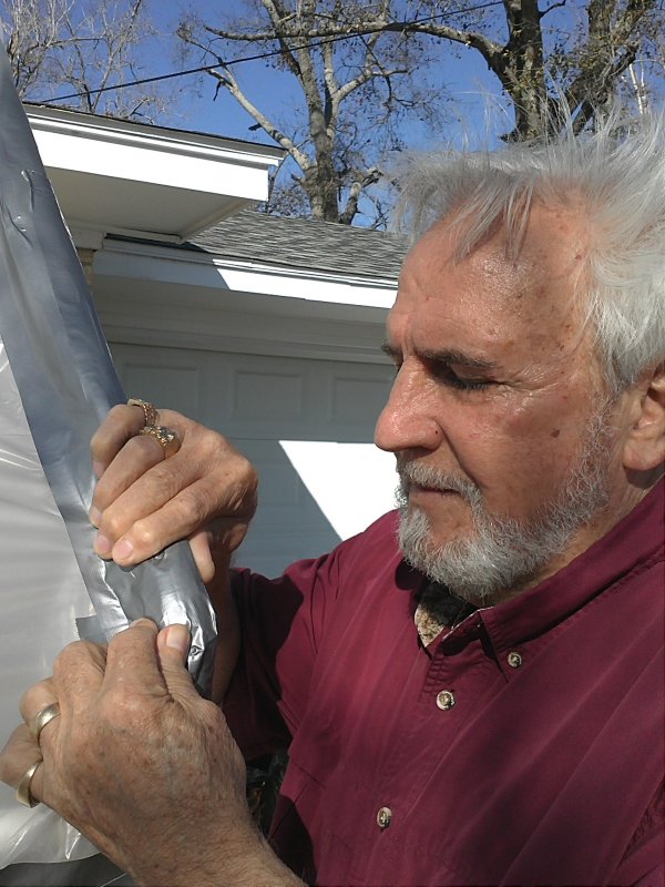 BJ duct-taping the greenhouse.jpg