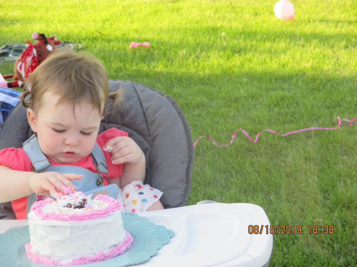 Evelyn touches cake.JPG