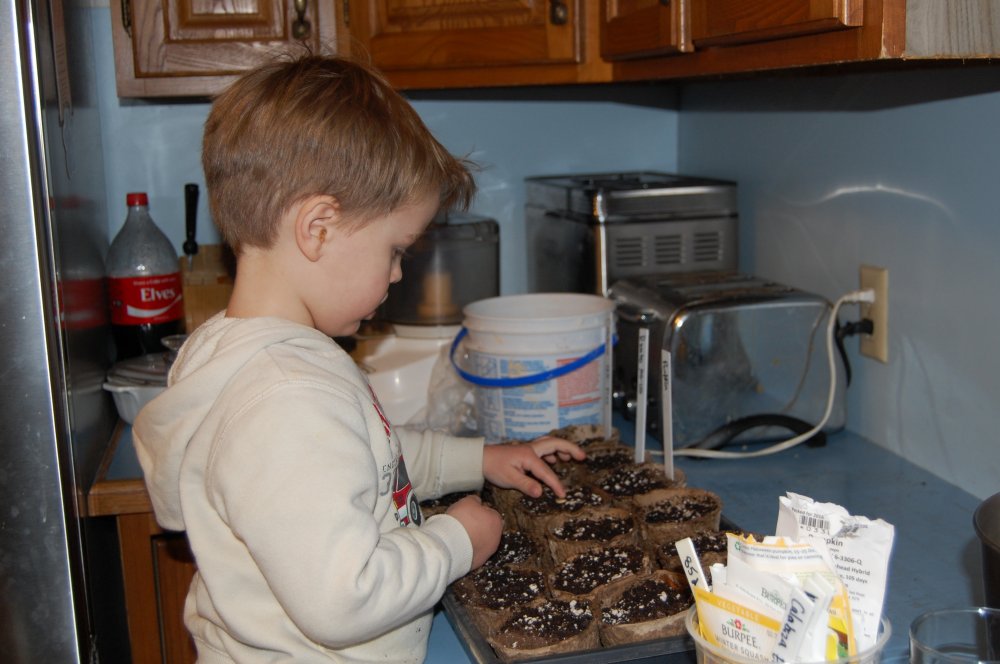 Landon planting seeds.JPG